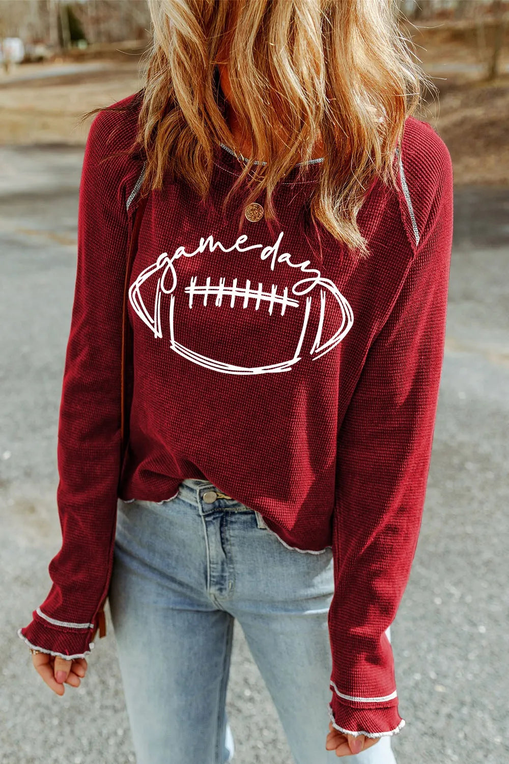 Burgundy waffle knit crewneck top with white football graphic and contrast stitching