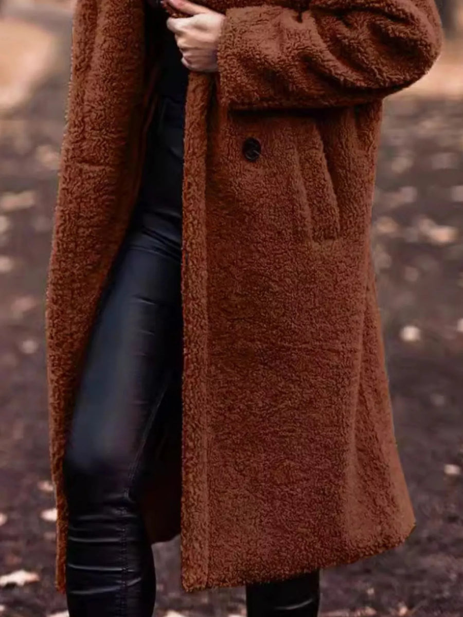 Brown teddy bear longline coat with button closure and pocket detail.