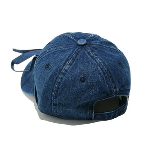 Denim baseball cap in navy with a bow tie detail at the back.