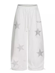 White wide leg sweatpants with all-over silver star embellishments and drawstring waist.