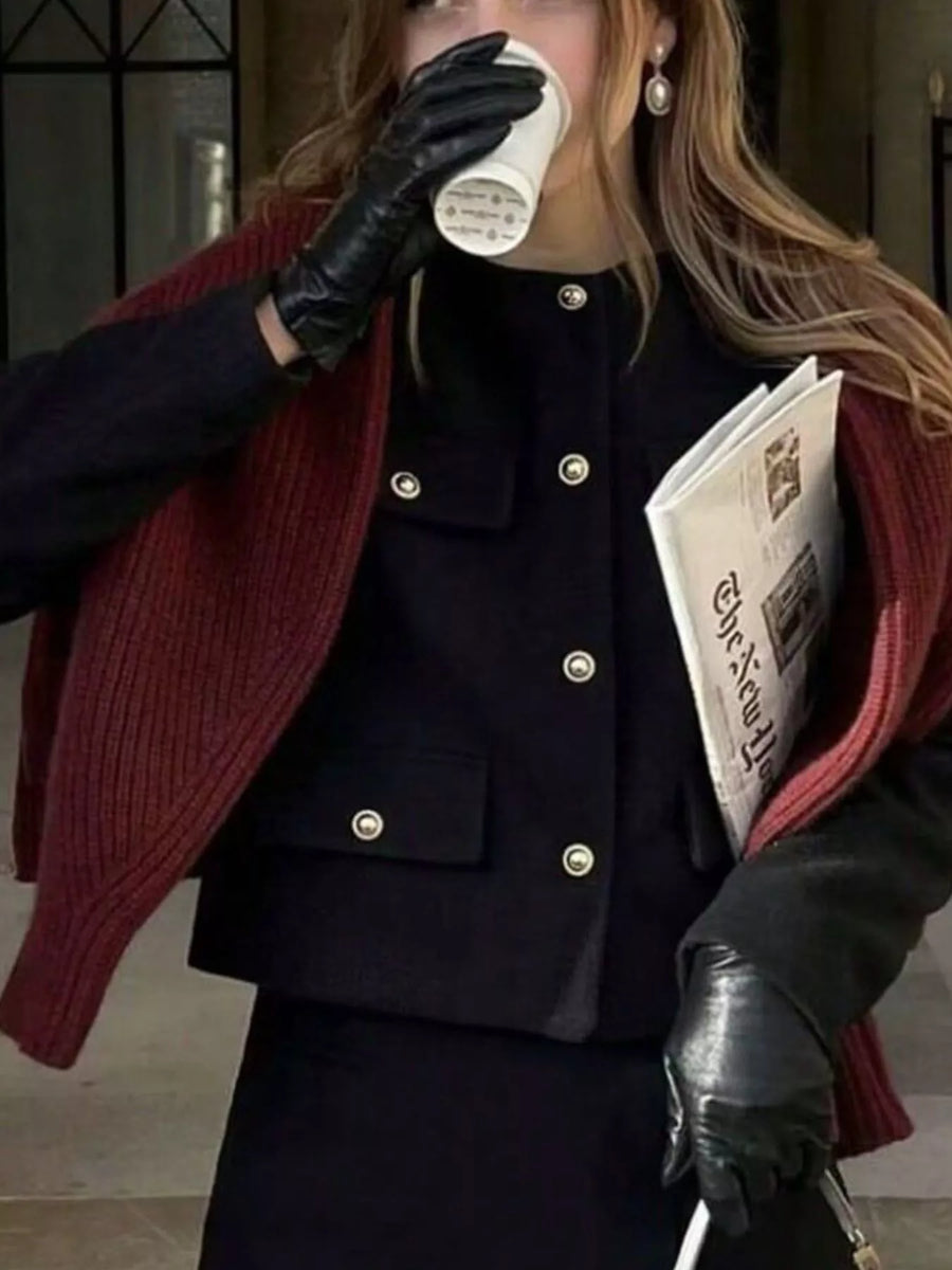 Black cropped tweed button-up jacket with gold buttons and flap pockets.