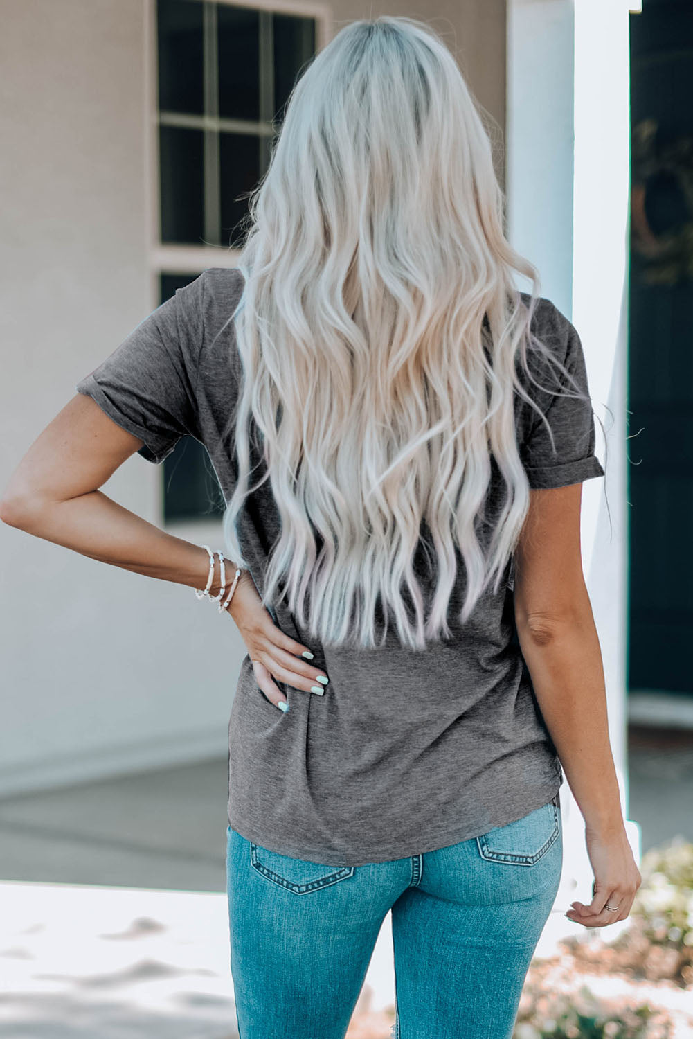Mid Gray t-shirt with rolled sleeves and a casual fit, paired with blue jeans.