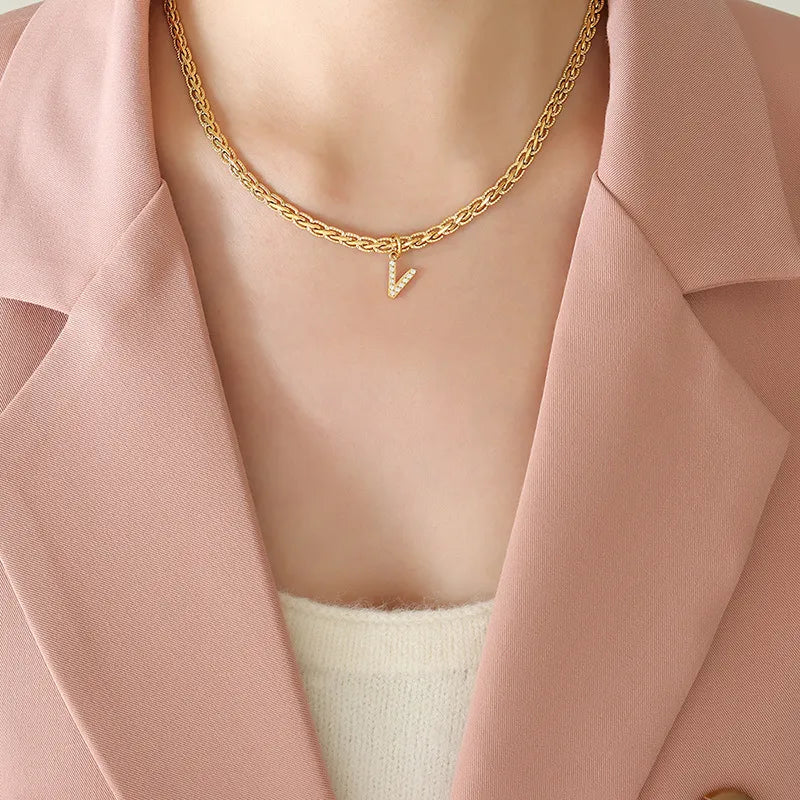 Gold textured chain necklace with a crystal initial V charm