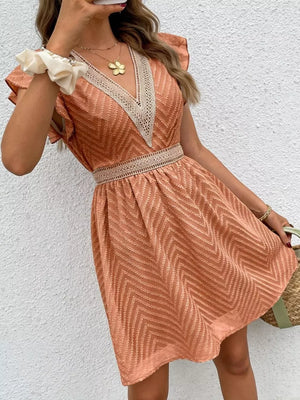 Burnt coral chevron textured mini dress with V-neck and defined waist