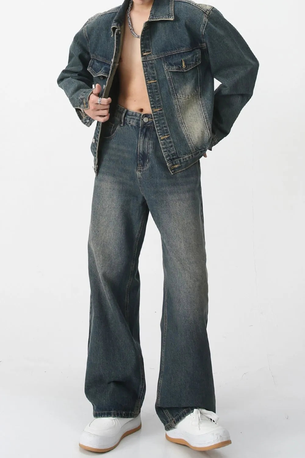 Medium wash denim trucker jacket with chest pockets and relaxed fit jeans.