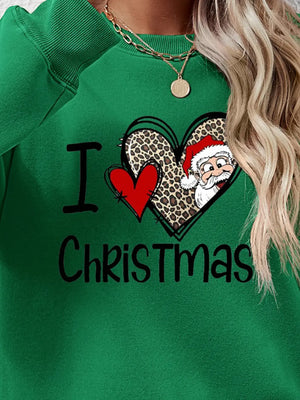 Green crewneck sweatshirt with festive heart graphic and Santa Claus saying I Love Christmas.