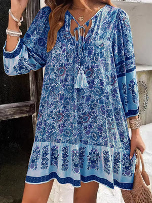Light Blue floral tassel tie mini dress with tiered hem and peasant sleeves.