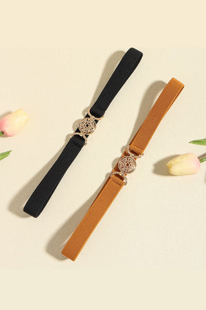 Elasticated belt in black and caramel with medallion buckle detail