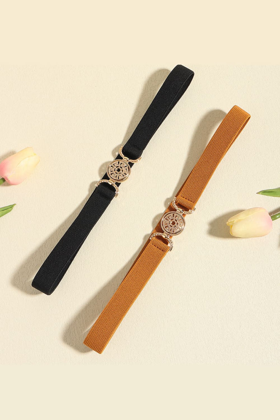 Elasticated belt in black and caramel with medallion buckle detail