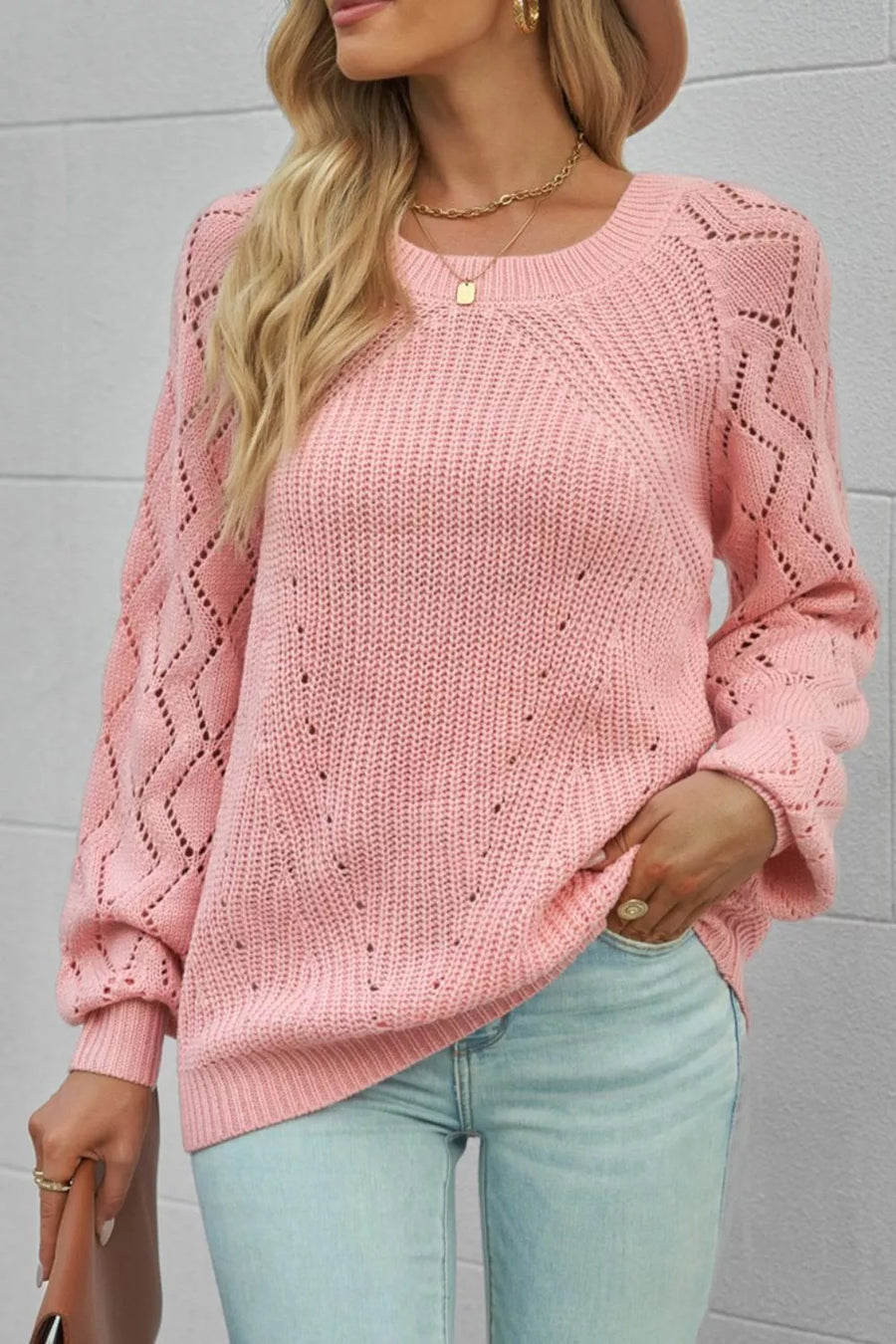 Dusty pink knit sweater with hollow-out puffy sleeves and diamond pattern detail.
