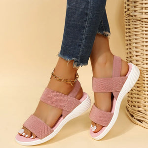 Dusty Pink knit strap sandals with white soles and a gold ankle bracelet.