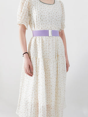 Lavender elastic belt with silver clasp detail worn with a floral dress