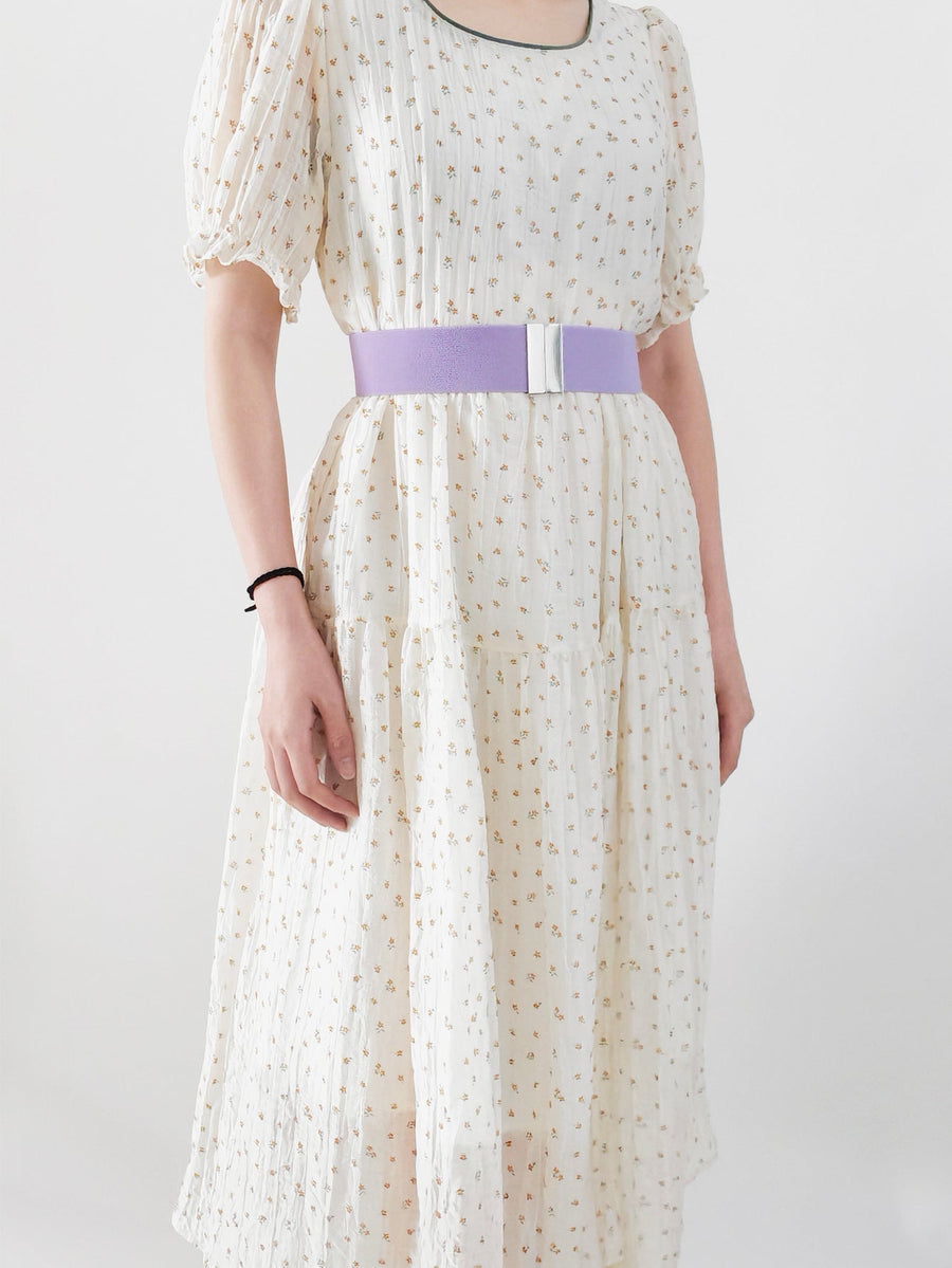Lavender elastic belt with silver clasp detail worn with a floral dress