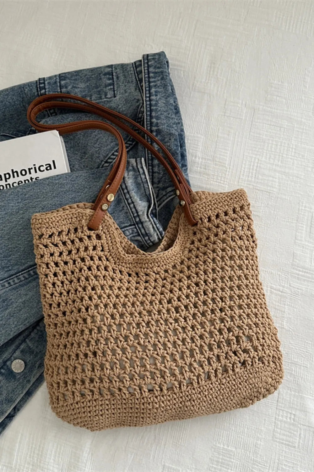 Crochet weave shoulder bag in camel with leather straps, styled casually.