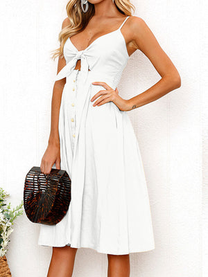 White midi sundress with bow front, button detail, and cami straps.