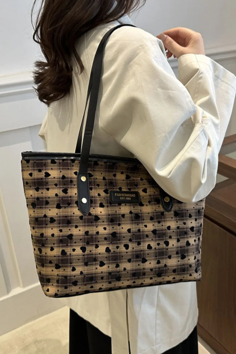 Heart plaid canvas tote bag with leather trim in camel and black.