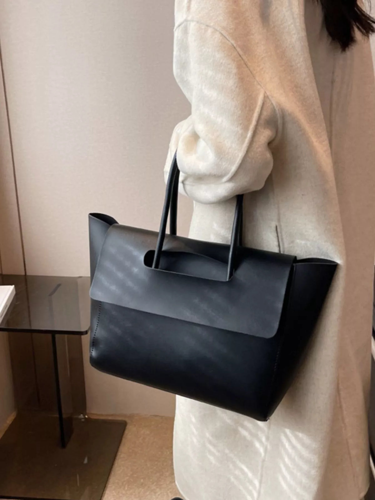 Black PU leather tote shopper bag with a fold-over flap and top handles.