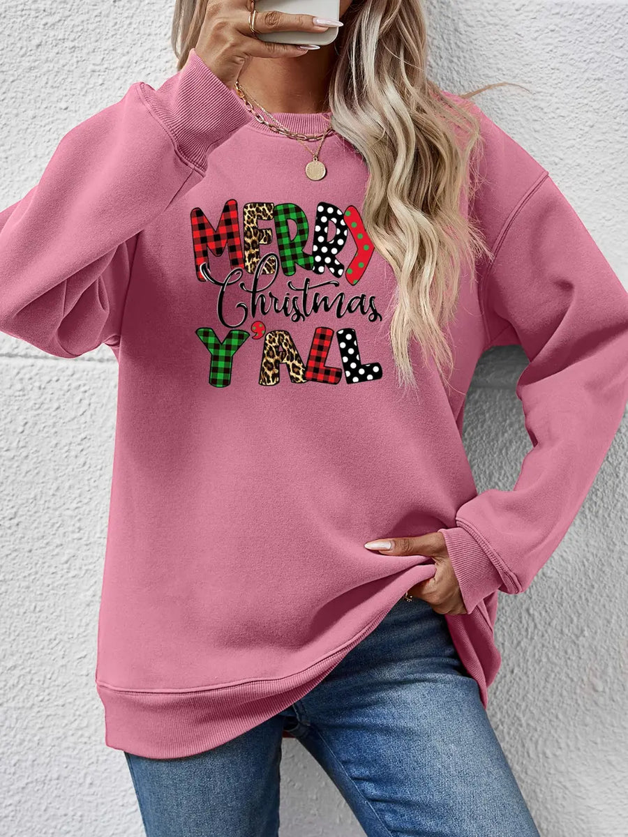 Blush pink crewneck sweatshirt with Merry Christmas Y'all graphic in mixed prints and patterns.