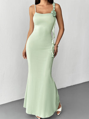 Ruffled mermaid maxi dress in light green with spaghetti straps and a floral detail.