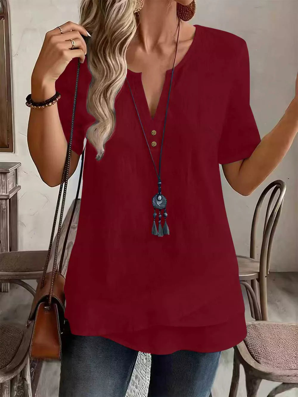 Burgundy blouse with decorative buttons and short sleeve