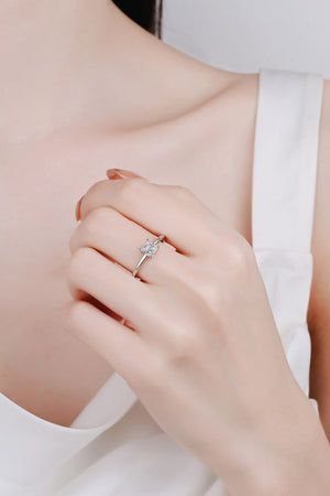 Prism cut moissanite silver ring with a square-shaped stone on a delicate band.
