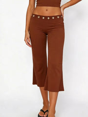 Dark brown maternity capri pants with flared hem and decorative button detail at the waist.