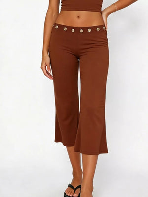 Dark brown maternity capri pants with flared hem and decorative button detail at the waist.