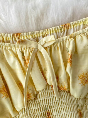 Yellow floral ruffled crop top with smocked waist and tie detail