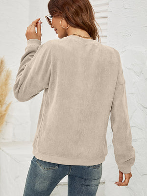 Sand textured corduroy crewneck sweatshirt with long sleeves.