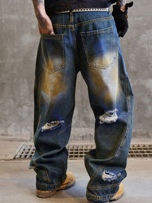 Men's distressed wide-leg jeans in blue cotton with ripped details and faded wash.