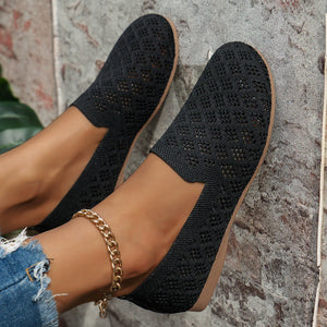 Black diamond knit loafers with a tan sole, featuring a gold chain anklet.