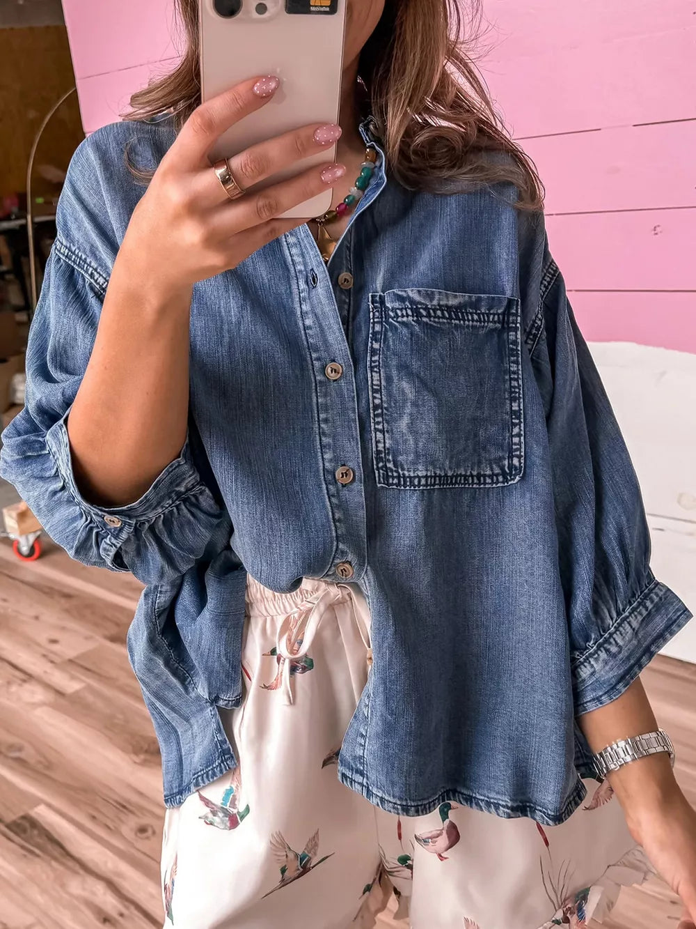 button-up shirt in denim blue featuring chest pocket and loose fit
