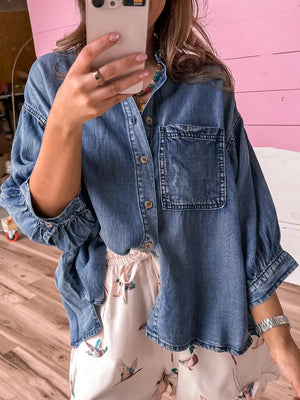 button-up shirt in denim blue featuring chest pocket and loose fit