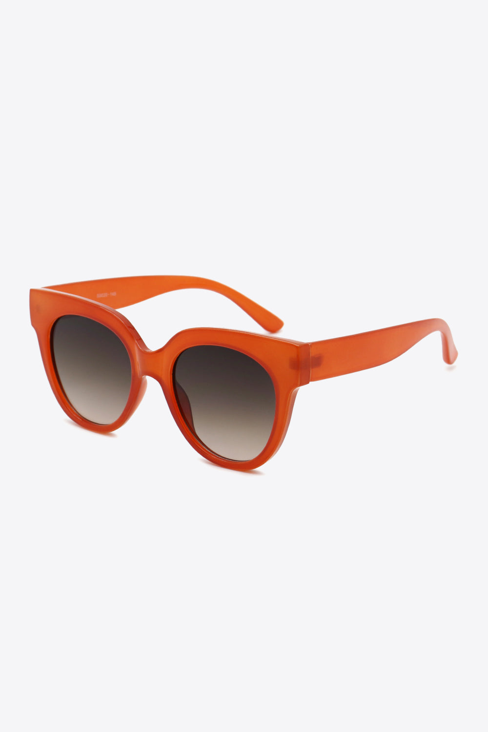Sunset cat-eye sunglasses in deep red with gradient lenses and thick frames.