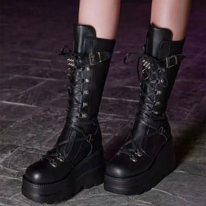 Black platform lace-up combat boots with buckles and spikes.