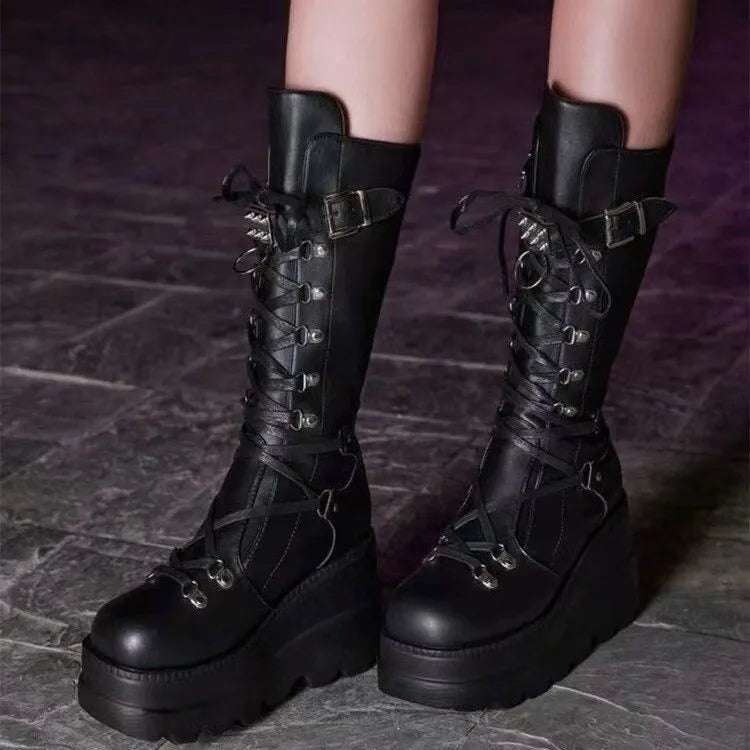 Black platform lace-up combat boots with buckles and spikes.