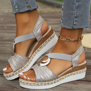 Light gray espadrille wedges with metallic leaf pattern and silver ring detail.