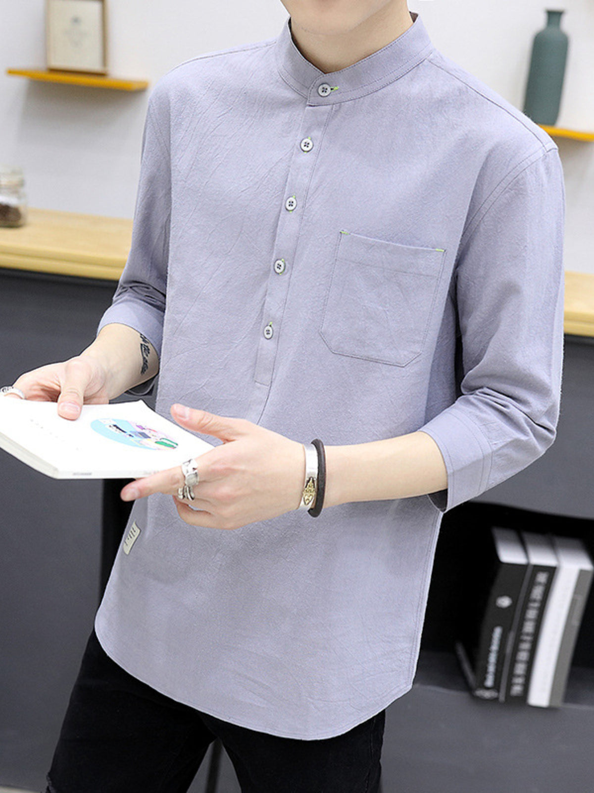 Relaxed-fit grey cotton shirt with mandarin collar, button detail, and chest pocket.