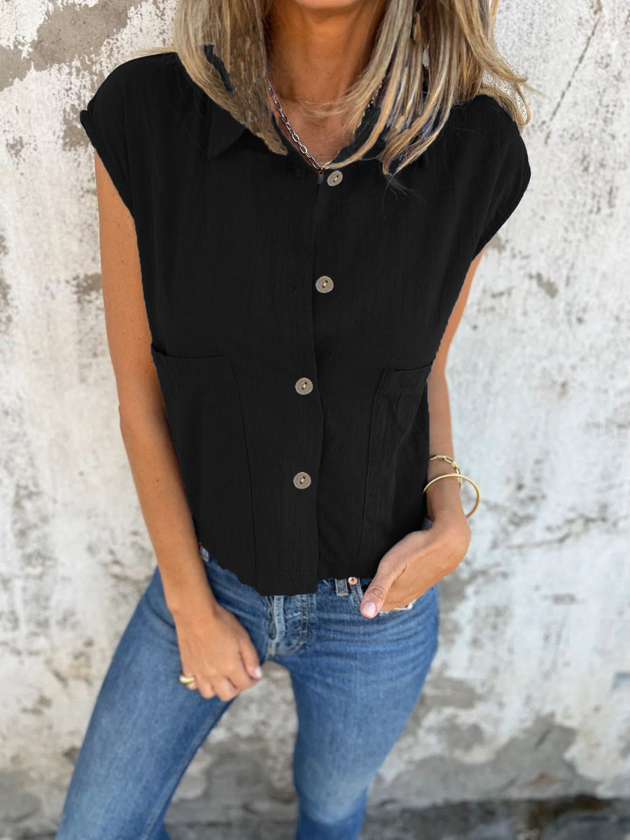 Black button-down cap sleeve shirt with two front pockets and a cropped fit.