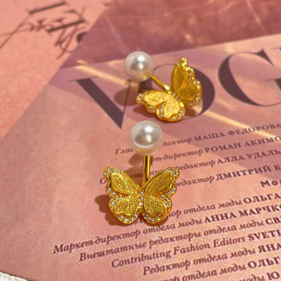 white earrings featuring pearl accent and butterfly