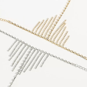 Rhinestone fringe hand chain bracelet in gold and white k, 18K gold-plated with dangling chains.