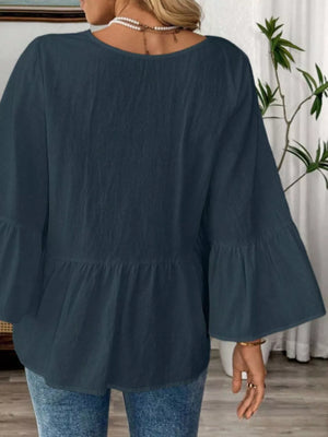 Navy blue cotton V-neck blouse with bell sleeves and tiered hem