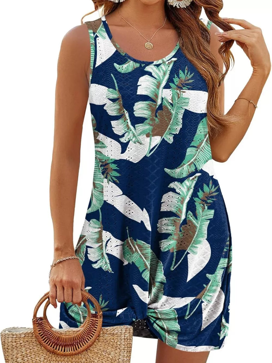 Navy blue tropical leaf print eyelet tank dress with twisted hem detail.