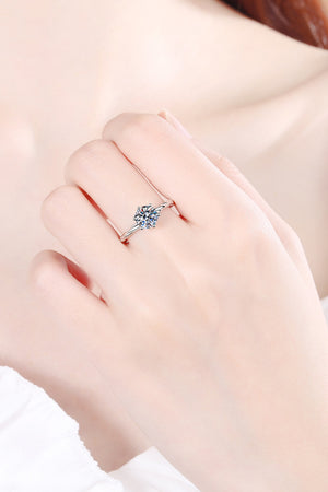 Silver moissanite solitaire ring with twisted band detail.