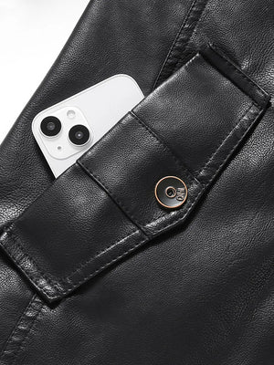Black faux leather jacket with buttoned pocket detail and visible phone.
