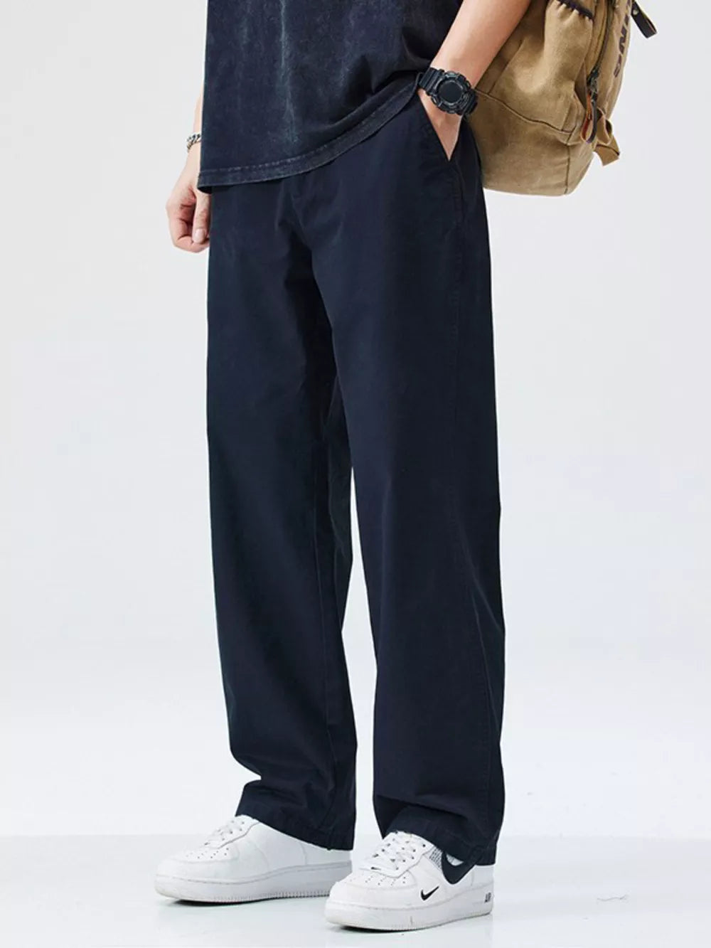 Dark navy utility-inspired loose-fit men's cargo pants with side pockets.